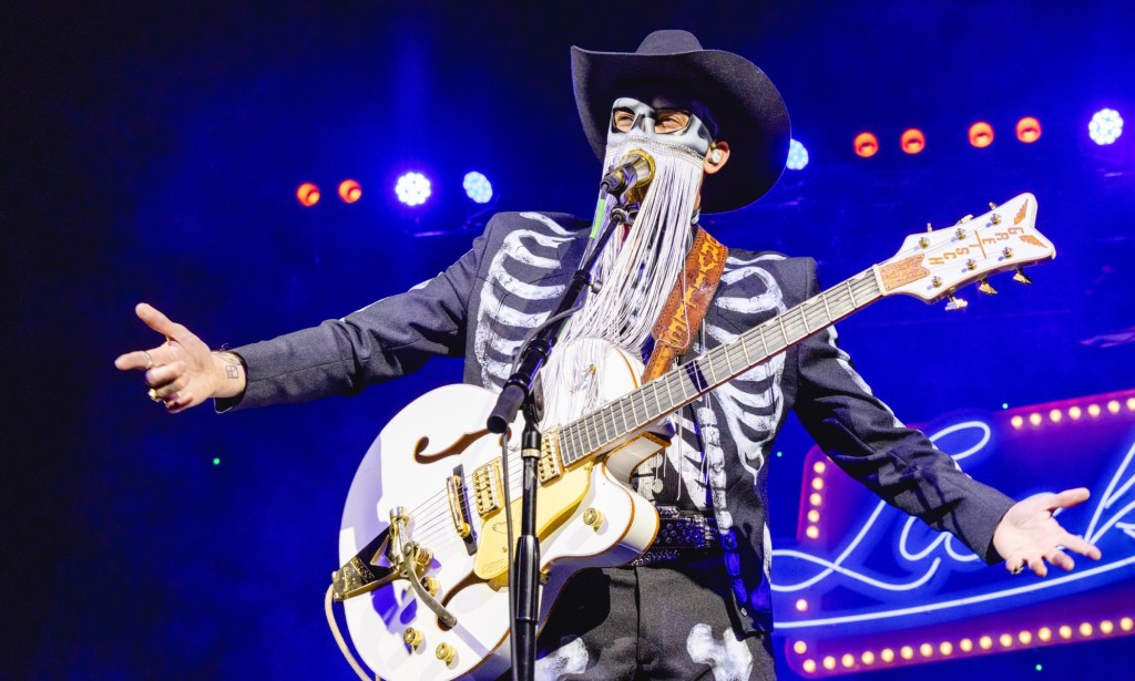 Orville Peck performs with signature fringe mask
