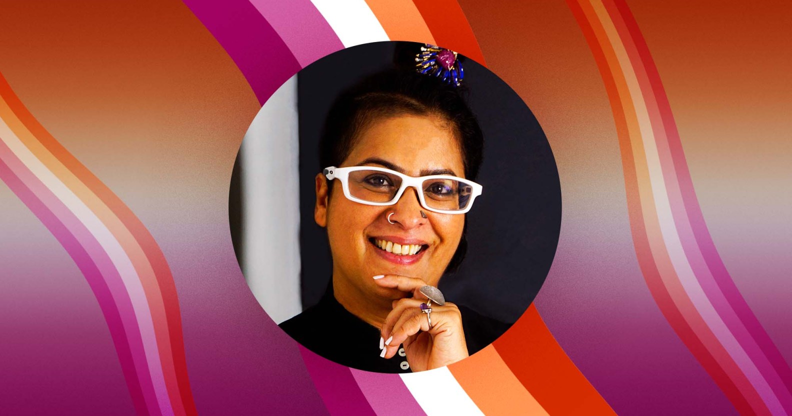 Author and entrepreneur Raga D'silva with lesbian Pride colours pictured behind her.