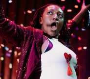 Yolanda Ovide wearing a white vest with heart shaped pasties, confetti rains down over her