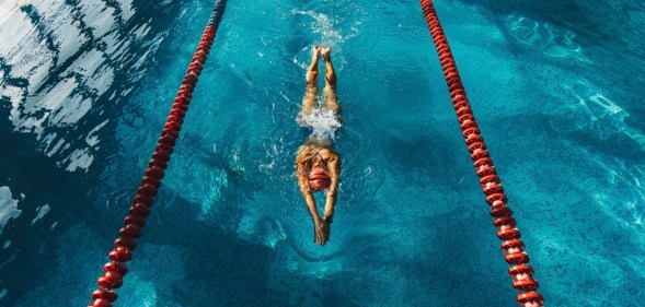 Stock image of person swimming in indoor lanes to illustrate Swim England story