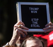 A Trump supporter holds a sign that says "Trump Won" at the Stop the Steal rally at the Georgia Capitol Building on Wednesday 18 November, 2020