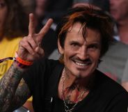 Tommy Lee giving a peace sign.