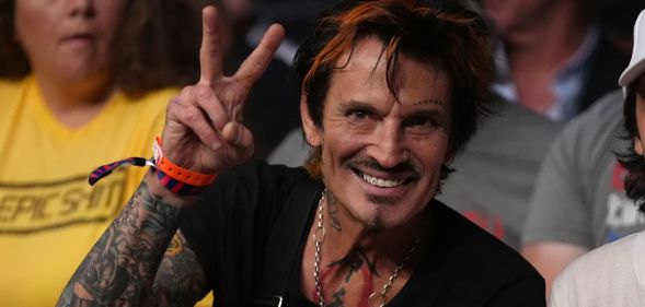 Tommy Lee giving a peace sign.
