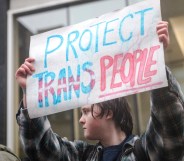 A person holds a sign reading 'Protect Trans People' as LGBTQ activists protest in Canada