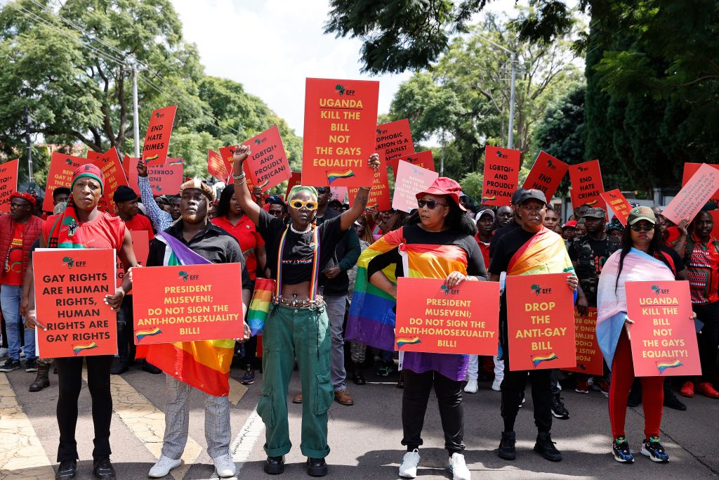 Economic Freedom Fighters leader Julius Malema (2nd R) looks on as Ugandas queer activist Papa De (C-L) raises a fist while picketing with others against the country's anti-homosexuality bill outside the high commission in Pretoria. 
