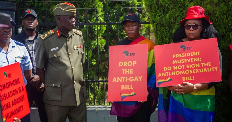 Uganda protestors hold signs urging the president to drop the anti-gay bill.