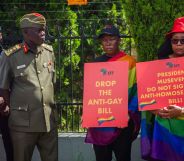 Uganda protestors hold signs urging the president to drop the anti-gay bill.
