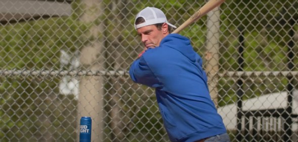 Seth Weathers hits a can of Bud Light with a baseball bat as part of an advert for Ultra Right Beer