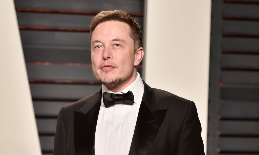 Twitter boss Elon Musk wears a suit and tie as he looks somewhere off camera