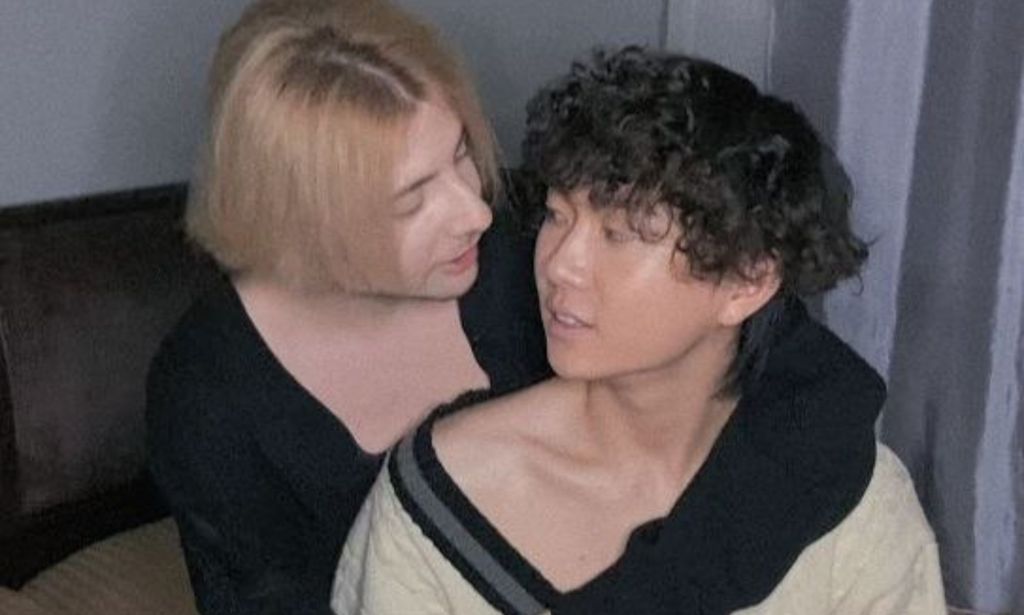 Russia based LGBTQ+ couple Haoyang Xu and Gela Gogishvil hold each other close as they look into each others' eyes