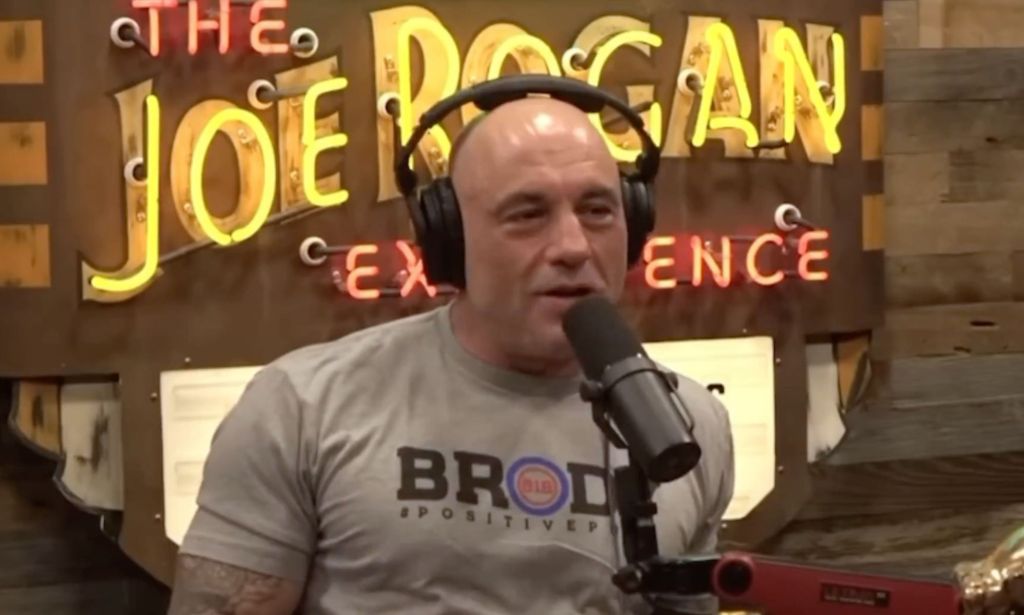 Controversial podcaster Joe Rogan wears a grey t-shirt as he discusses the controversy over trans influencer Dylan Mulvaney's partnership with Bud Light and Nike