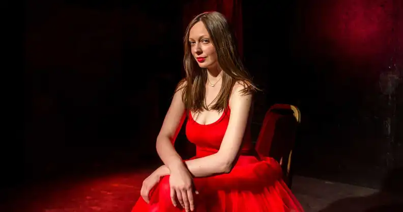 Maggie Lalley wearing a long red dress
