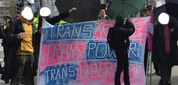 Protesters with a sign reading trans rage, trans power, trans liberation