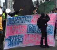 Protesters with a sign reading trans rage, trans power, trans liberation