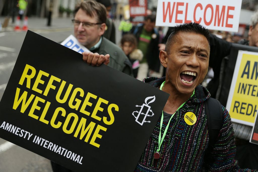 Demonstrators take part in a march calling for the British parliament to welcome refugees in the UK in central London.