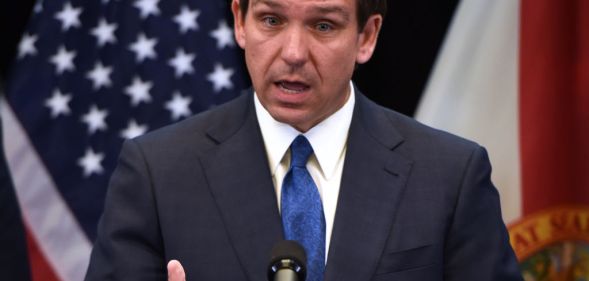 Ron DeSantis speaking in front of a US flag
