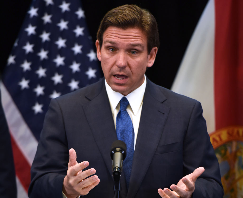Ron DeSantis speaking in front of a US flag