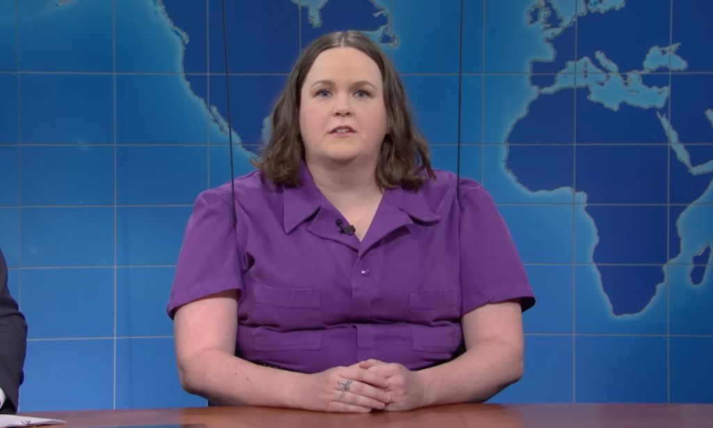 Saturday Night Live (SNL) cast member Molly Kearney wears a purple jumpsuit as they appear on the "Weekend Update" segment to talk about trans rights amid legislative efforts to ban access to gender-affirming healthcare for trans kids