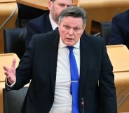 Scottish Tory MSP Stephen Kerr wears a suit and tie as he speaks before politicians gathered in Holyrood. He has been an opponent of Scotland's pro-trans Gender Recognition Reform bill