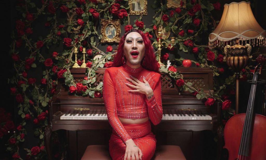South Korean LGBTQ+ activist Heezy Yang is dressed, as his drag persona Hurricane Kimchi, in a red outfit as he sings