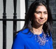 UK home secretary Suella Braverman wears a blue outfit and silver necklace as she steps outside. LGBTQ+ and human rights campaigners have criticised Braverman for her comments about asylum seekers