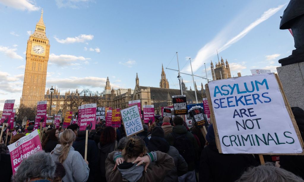 People protest against the UK government's scheme to deport asylum seekers, including those from Sudan who travel to the UK via small boats to escape conflict or persecution because they're LGBTQ+, to Rwanda