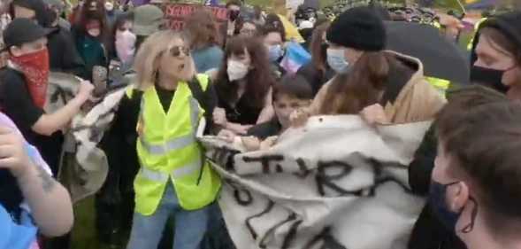 A Let Women Speak steward was filmed attempting to destroy a banner of pro-LGBTQ+ campaigners. (Twitter/@ICanS