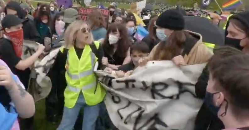 A Let Women Speak steward was filmed attempting to destroy a banner of pro-LGBTQ+ campaigners. (Twitter/@ICanS