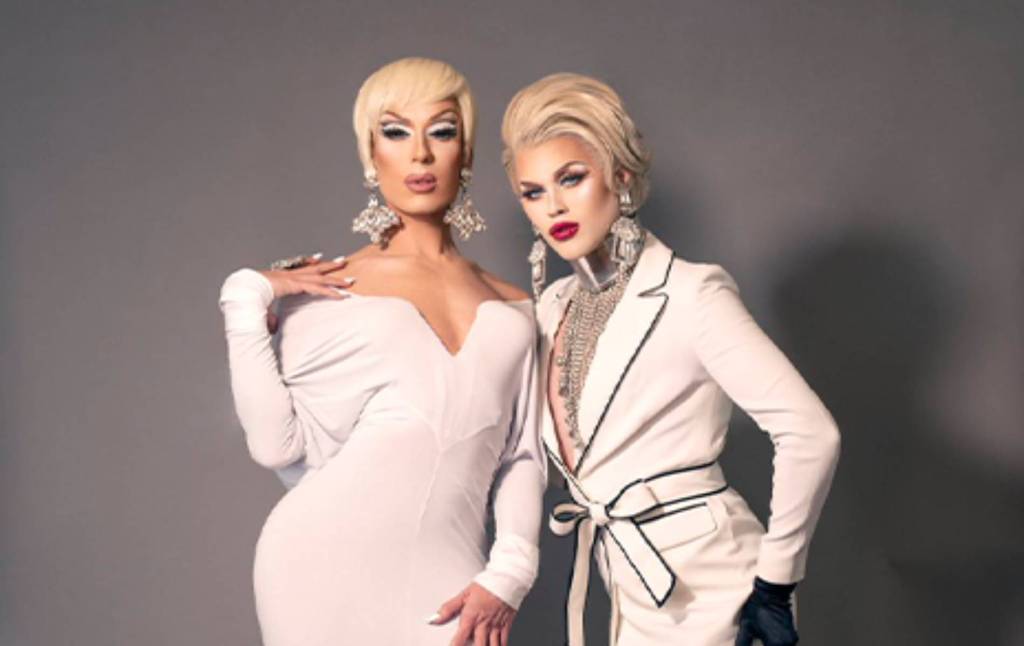 Drag Race icon Alaska Thunderf**k and her Drag Queen of the Year co-host Lola LeCroix stand side by side while wearing white
