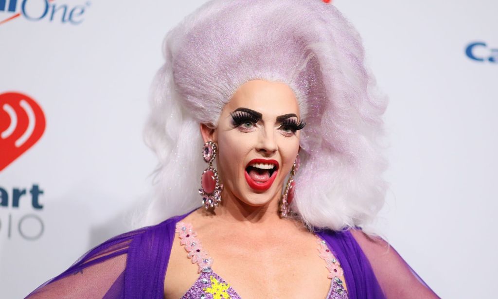 Drag Race star Alyssa Edwards in a pink and yellow top and violet blonde wig.