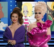 Drag queens Trixie Mattel and Trinity the Tuck stand in front of a backdrop featuring the character Roger from American Dad