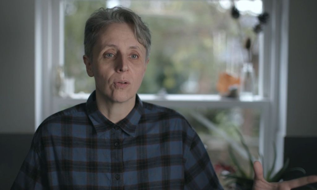 A screenshot of Kathleen Stock, an anti-trans campaigner, wearing a blue and black plaid shirt during an interview for Channel 4's Gender Wars documentary