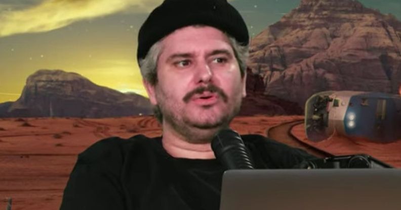 H3 Podcast host Ethan Klein infront of a green screen.