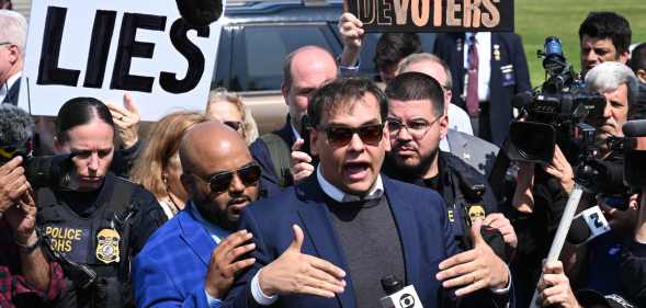 George Santos surrounded by reporters