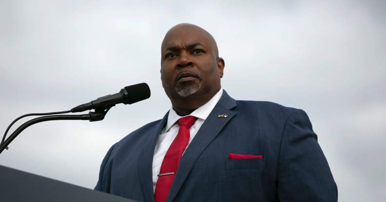 North Carolina lieutenant governor Mark Robinson speaks at a podium wearing a blue suit and red tie