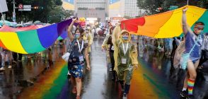 LGBT rights activists carry large rainbow banners as they march during the Gay Pride Parade in Taipei on October 29, 2022