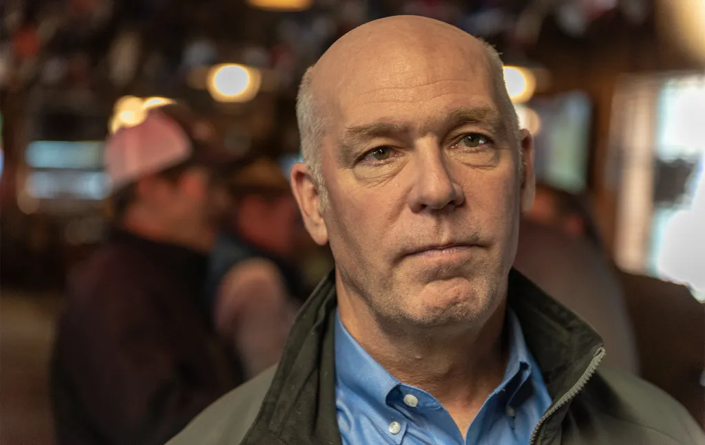 Montana governor Greg Gianforte wearing a jacket in a bar.