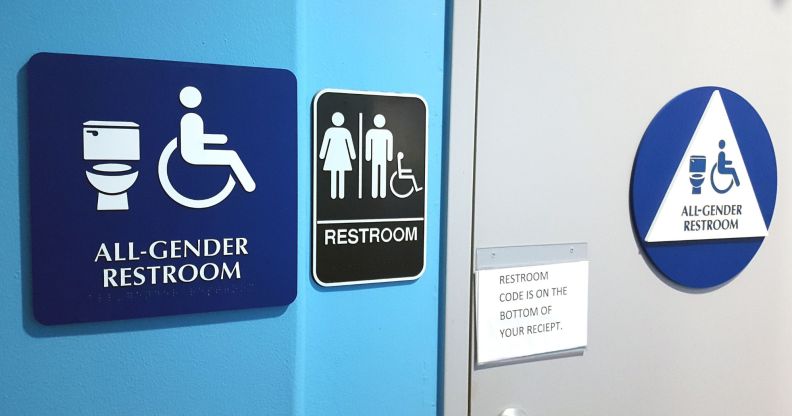 A set of sigjns indicating a gender-neutral bathroom facility.