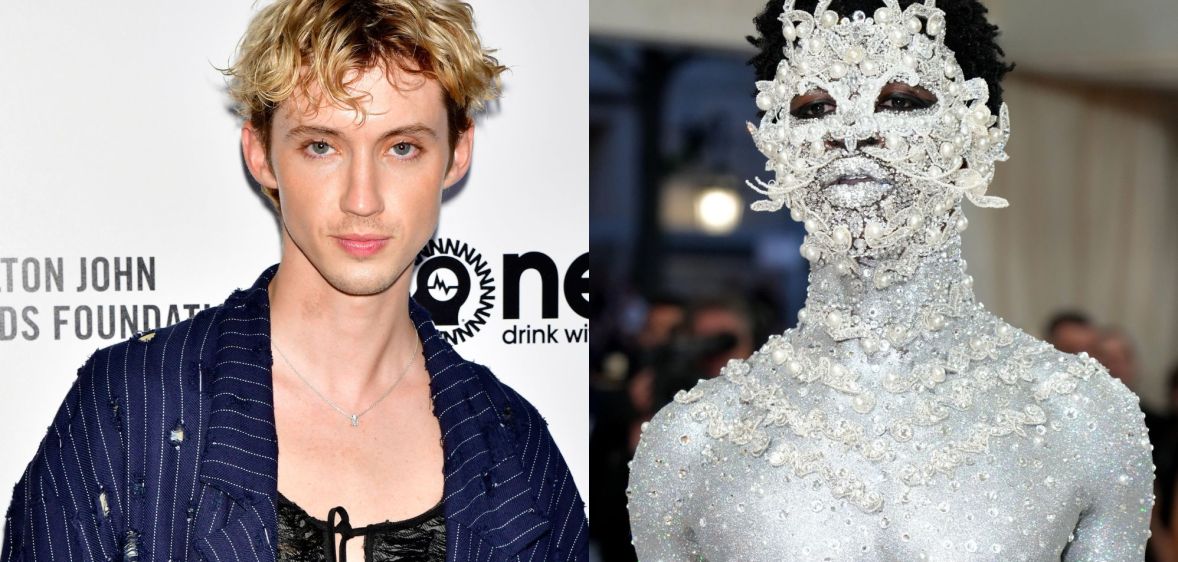 On the left, Troye Sivan in a black top and blue jacket. On the left, Lil Nas X painted silver head to toe.