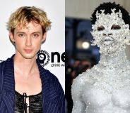On the left, Troye Sivan in a black top and blue jacket. On the left, Lil Nas X painted silver head to toe.