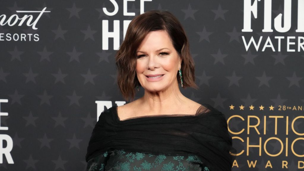 Close-up image of Marcia Gay Harden standing in front of a dark grey background