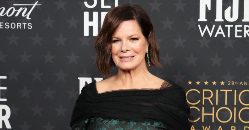 Close-up image of Marcia Gay Harden standing in front of a dark grey background