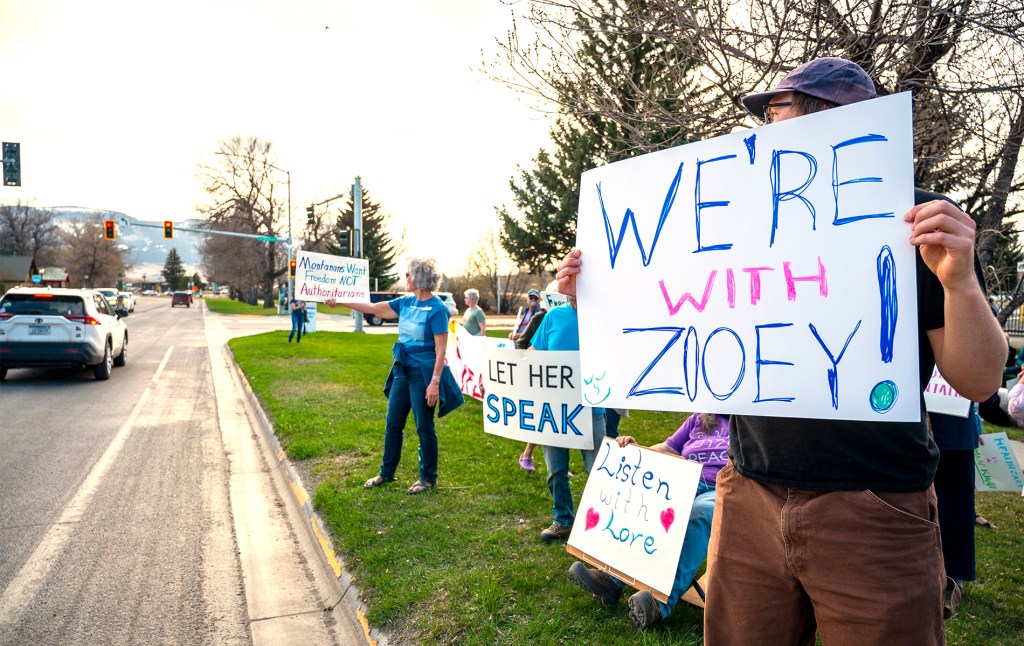 Montana activists holding signs that say "we're with [Zooey!]"