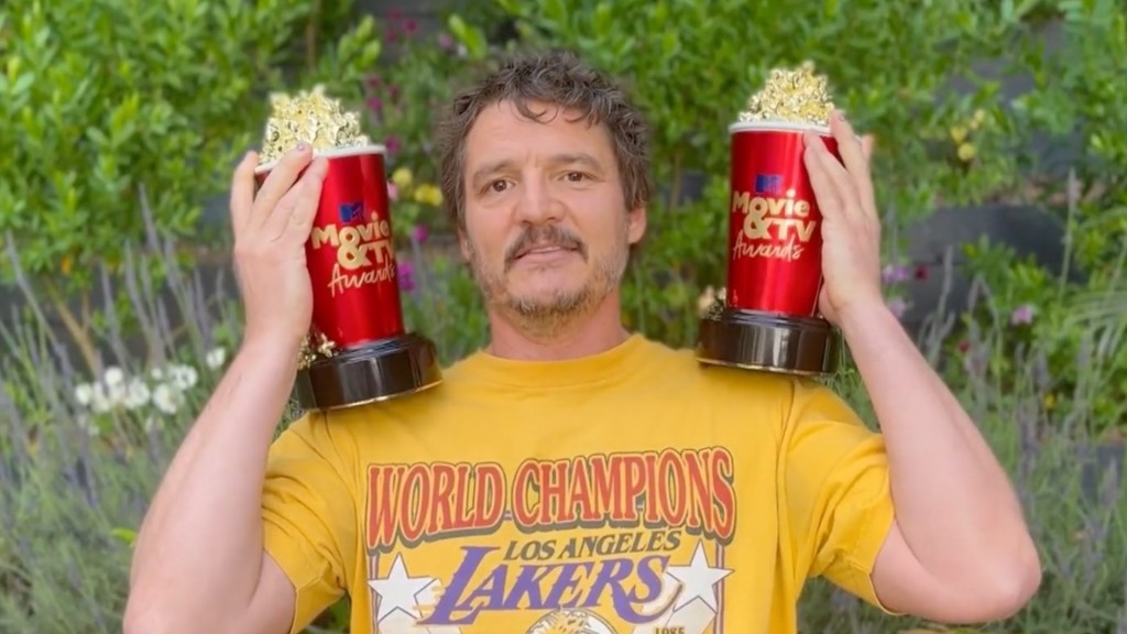 Pedro Pascal holds up two popcorn-shaped awards for the MTV Movie and TV Awards