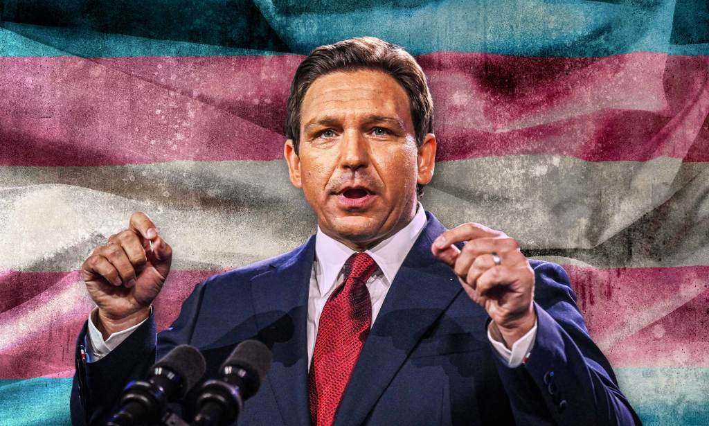Ron DeSantis in front of a tranas flag