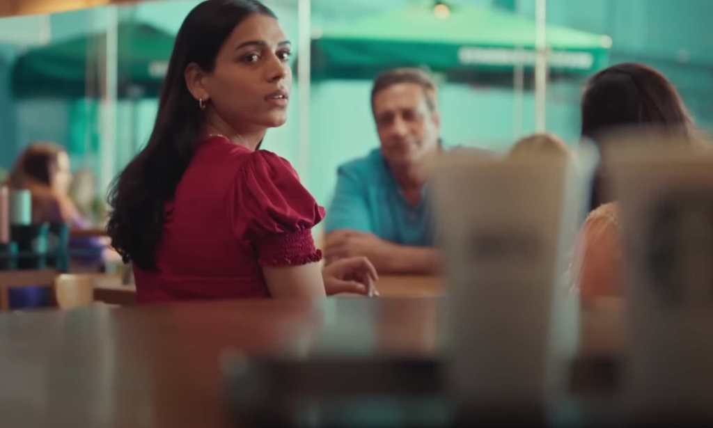 Screenshot from Starbucks ad showing Arpita looking at coffees