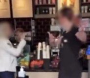 A screenshot of a video showing a Starbucks barista speaking to a customer