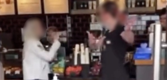 A screenshot of a video showing a Starbucks barista speaking to a customer