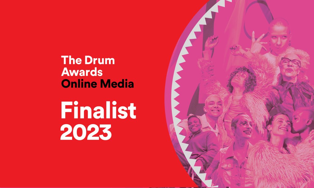A group of people celebrating next to text reading 'The Drum Awards Online Media Finalist 2023'