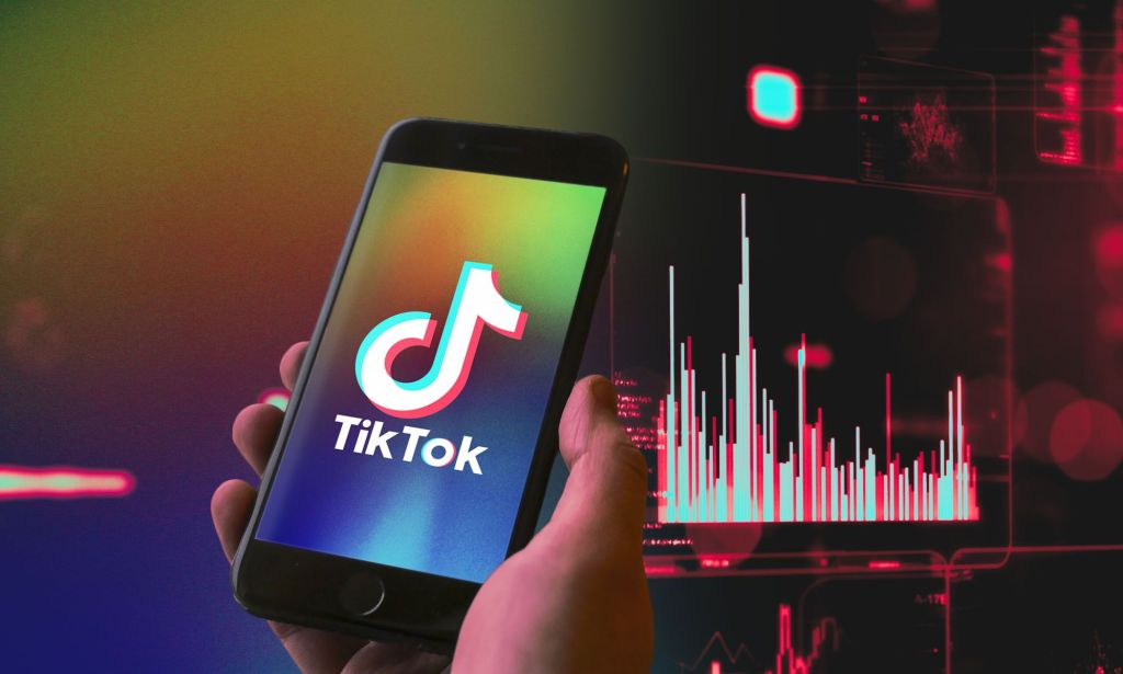 Hand holds phone with TikTok logo on the screen
